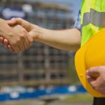 handshake with yellow hard hat